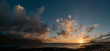Panorama Of An Ocean Sunset With Illuminated Clouds