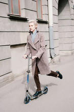 Young Woman Going On A Scooter