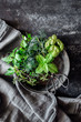 © Pixel Stories/Stocksy - Fresh green herbs in a metal bowl