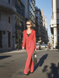 © xo4uphoto - woman in red suit walking at the street