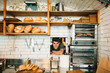 © BONNINSTUDIO/Stocksy - Portrait of a young man working in a pastrami sandwich bar.