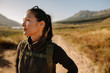 © Jacob Ammentorp Lund/Stocksy - Asian female backpacker standing outdoors