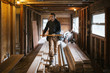 © Rob and Julia Campbell/Stocksy - Carpenter man working on jobsite