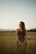 © Joseph West Photography/Stocksy - Pretty girl runs through field near beach