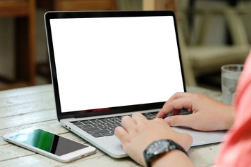 Man hands typing laptop computer with blank screen for mock up template background, business technology and lifestyle background concept
