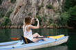 © AD Photography/Stocksy - Woman kayaking and taking photos