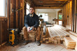 © Rob and Julia Campbell/Stocksy - Carpenter man taking break on jobsite - drinking water