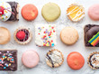 © Jeremy Pawlowski/Stocksy - Chocolate covered rice crispies, tarts, and macaroons from bakery