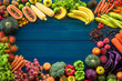Top view of fresh fruits and vegetables organic on table, Frame of multicolour fresh fruits and vegetables with copy space on blue plank