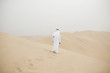© Photography by Maja Topcagic/Stocksy - A man wearing abaya walking in the desert