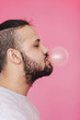 © Sergey Filimonov/Stocksy - Charismatic man blowing pink bubble gum
