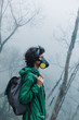 © Duet Postscriptum/Stocksy - Female in mask walking on volcano