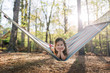 © Jakob/Stocksy - Cute young girl relaxing in a hammock