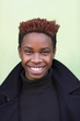 © Fjello/Stocksy - Young black man smiling.