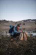 © Alexandr Ivanets/Stocksy - Male tourist making campfire