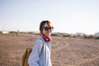 © zheng long/Stocksy - young fashion lady listen music with wireless headset