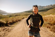 © Jacob Ammentorp Lund/Stocksy - Smiling young woman hiking with backpack