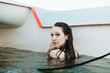 © Aaron Thomas/Stocksy - Young Woman Sailing and Swimming