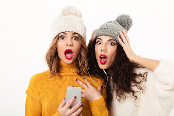 Poster - Close up image of Shocked girls in sweaters and hats