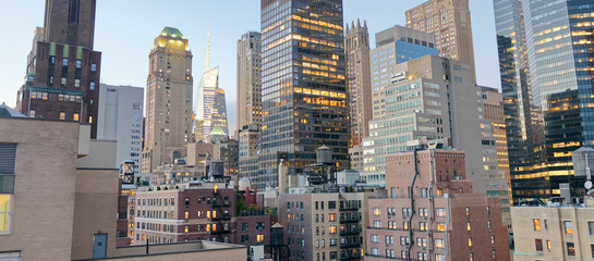 Poster - Midtown Manhattan skyscrapers as seen from city rooftop at sunse