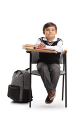 Poster - Little schoolboy sitting in a school chair