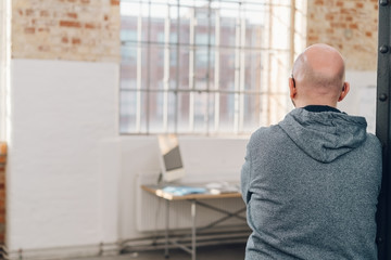 Wall Mural - Rear view of a man wearing gray hooded sweatshirt