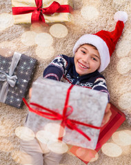 Wall Mural - Happy kid with presents at Christmas time

