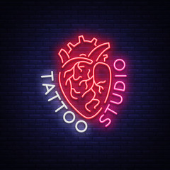 Wall Mural - Tattoo studio logo, neon sign, symbol of human heart, bright billboards, night banner, neon bright advertising on tattoos, for tattoo salon, studio. Vector illustration for your projects