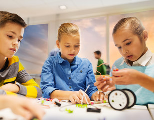 Wall Mural - happy children building robots at robotics school