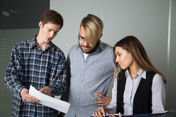 3 people work in the office, talking to, and address the issues of the company, smile and sign documents