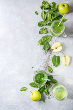 Variety Of Three Color Green Spinach Kale Apple Yogurt Smoothie In Mason Jars With Retro Cocktail Tubes And Ingredients Above Over Gray Texture Background. Healthy Vegan Detox Eating. Top View, Space
