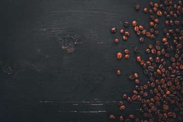 Coffee beans. On a wooden background. Top view. Copy space.