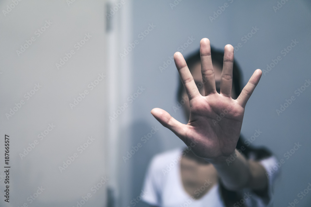 Women abused in her home holding her hand up. Stop sexual harassment against women. Violence and abuse in family relations. - obrazy, fototapety, plakaty 