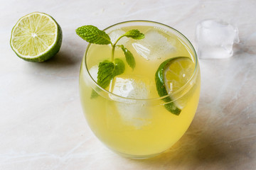 Wall Mural - Yellow Lemonade Cocktail with Lime and ice.