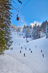 Poiana Brasov, Romania -12 January 2013 : Cable car in Poiana Brasov ski resort, Skiers and snowboarders enjoy the ski slopes in Poiana Brasov winter resort whit forests covered in snow