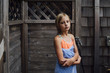 © Cavan Images - Portrait of girl with towel standing against log cabin
