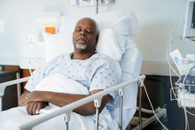 Senior Patient Sleeping On Bed In Hospital Ward