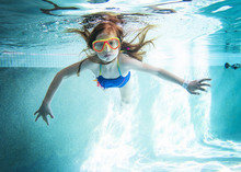 Portrait Of Girl Swimming Underwater In Pool