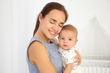 Poster - Portrait of young mother with cute baby at home