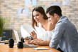 © Africa Studio - Two young photographers working in office
