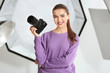 © Africa Studio - Beautiful young photographer with camera in professional studio
