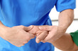 © Africa Studio - Physiotherapist giving hand massage to senior patient, closeup