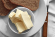 Composition with fresh butter and bread on table