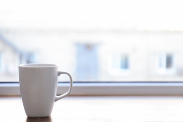 Poster - Ceramic cup on window sill