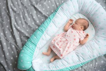 Wall Mural - Cute newborn baby girl lying on bed