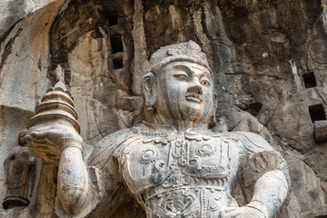 Wall Mural - Buddhist sculptures in Fengxiangsi Cave, the main one in the Longmen Grottoes in Luoyang, Henan, China. Longmen is one of the 3 major Buddhist caves of China, and a World heritage Site.