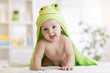 © Oksana Kuzmina - Baby boy wearing green towel in sunny bedroom. Newborn child relaxing after bath or shower.
