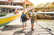 © Mirko Vitali - Happy senior couple walking holding hand at Koh Panyi muslim floating village - Active elderly and travel lifestyle concept with retired mature people at Phang Nga bay Thailand - Warm day filter