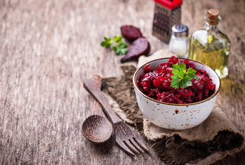 Wall Mural - Bowl of beetroot salad on wooden background