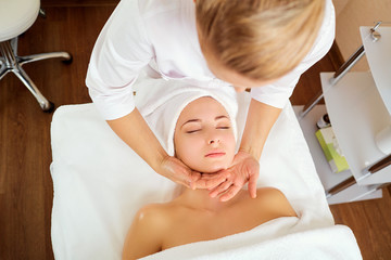 Wall Mural - beautiful woman at a facial massage at a spa salon.